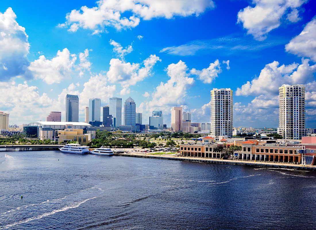 Tampa, FL - View of Commercial Buildings and Skyscrapers by the Bay in Downtown Tampa Florida with Boats and Yachts on the Water on a Sunny Day